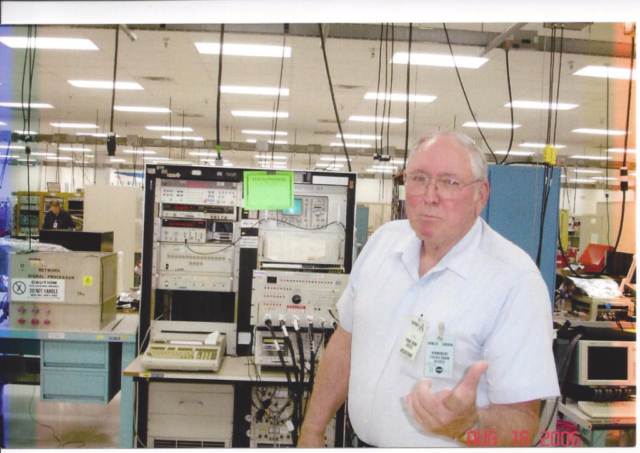 Jim posing in front of a console used for testing and repairing a Shuttle black box known as a Network Signal Processor (NSP) at NASA’s Shuttle Logistics Depot located in Cape Canaveral, FL.